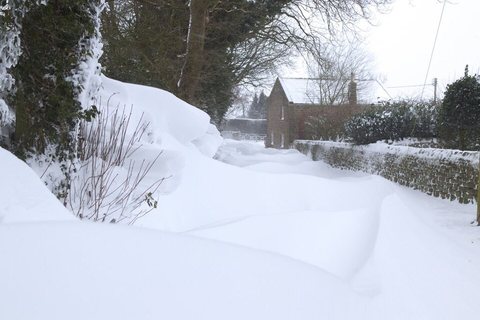 Deep snow drifts in a village lane, England, 1 March 2018